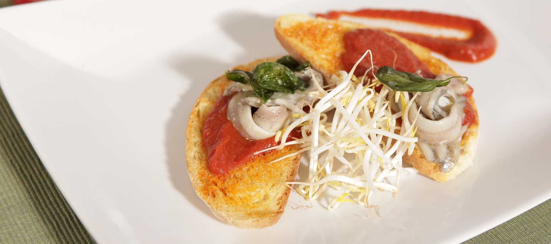 Bruschetta with marinated anchovies and fiery red sauce Bruschetta with marinated anchovies and fiery red sauce