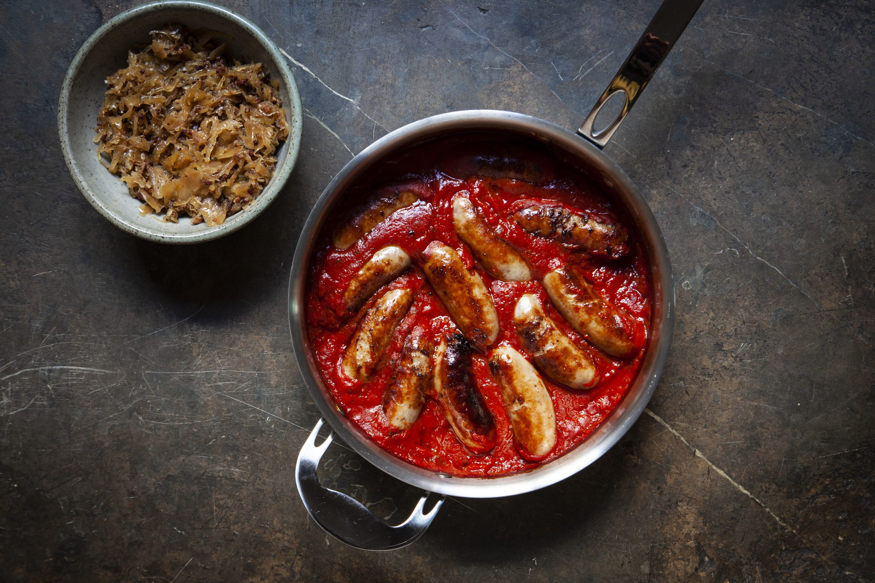 Lamb sausages in tomato sauce with bacon sauerkraut Lamb sausages in tomato sauce with bacon sauerkraut