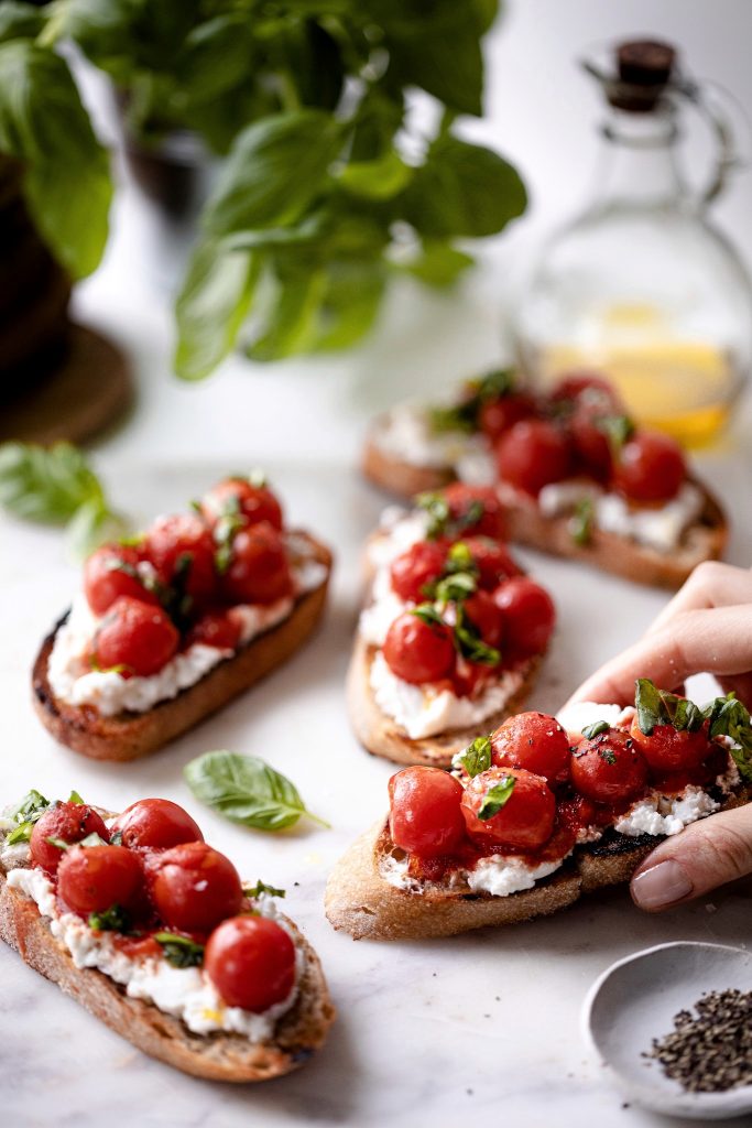 Grilled Crostini with warm cherry tomato topping and fresh basil Grilled Crostini with warm cherry tomato topping and fresh basil
