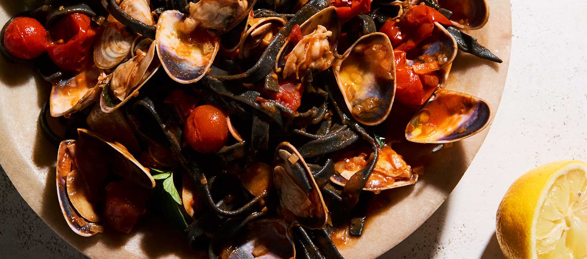 Pipis with Mutti Cherry Tomatoes and Squid Ink Fettuccini Pipis with Mutti Cherry Tomatoes and Squid Ink Fettuccini
